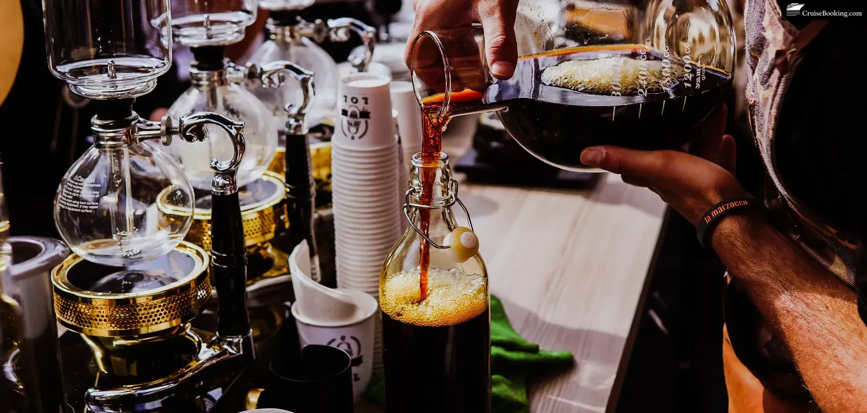 A person fills a glass with beverages and drinks