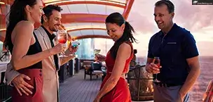 Celebrity_Cruise_Tips Two couples enjoying drinks and dancing on the deck of a Celebrity Cruises cruise ship at sunset