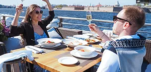 Cruise_Holidays Couples enjoy food and drinks on a cruise in winter