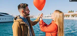 Young people with red balloon on Valentine Day