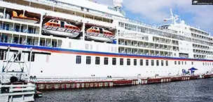 Europe Large cruise ship docked at harbor with lifeboats