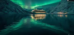 Europe Cruise ship under aurora borealis at night