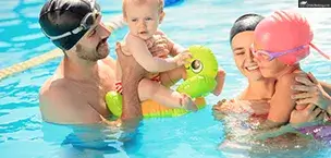 A happy family enjoying a swim in the pool