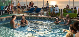 Cruise ship sun deck with pools and loungers at sea