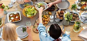 People enjoying delicious food at a table close-up