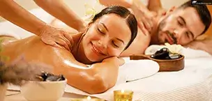 Smiling woman enjoying back massage at health spa