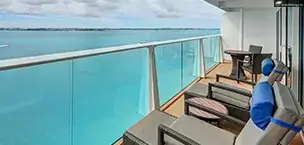 Balcony view from Anthem of the Seas, overlooking the calm ocean with clear blue skies.