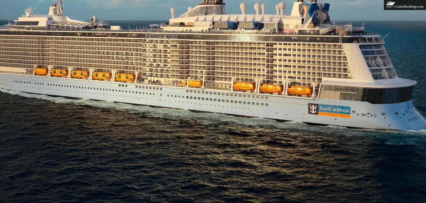 Anthem of the Seas at sea, with clouds and sunset