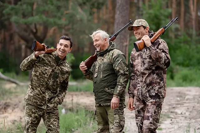 Happy men talking and laughing during a family hunting trip.