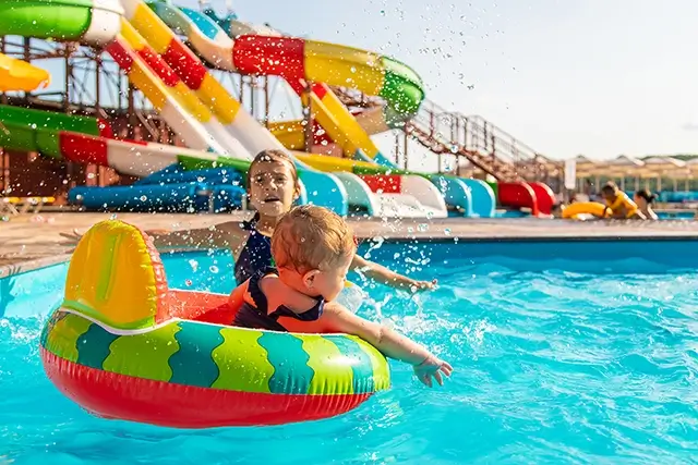 In the pool, the baby swims in a circle. Selective focus.