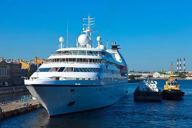 At Neva, there is a white cruise ship. The city of Saint Petersburg