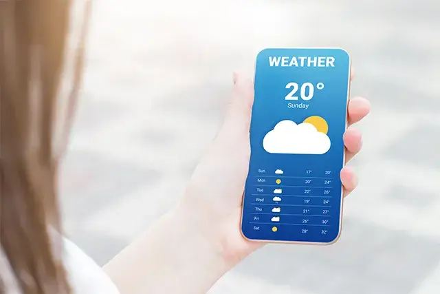 In a mobile application, the girl checks the weather forecast