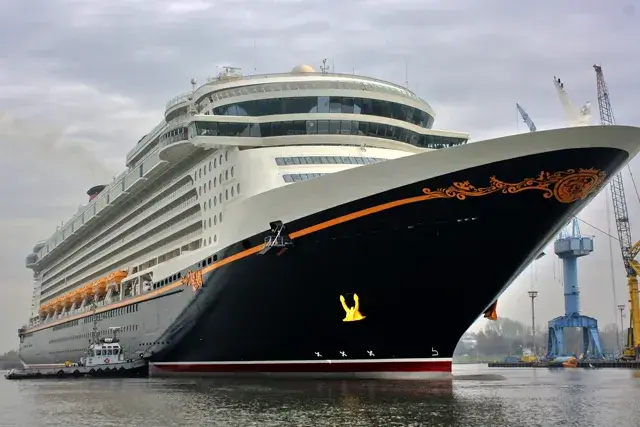 Large Disney cruise ship docked at harbor