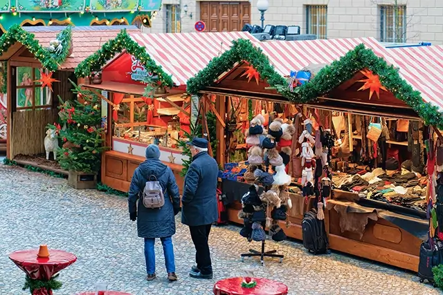 In Mitte of Winter Berlin, Germany, there is a Christmas market at the Opernpalais. On the bazaar, there are stalls with crafts items and decorations for the Advent fair