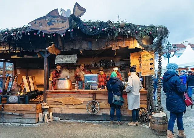 During the winter in Berlin, people are shopping at the Charlottenburg Palace's Christmas market. Bazaar decorations and crafts items for the advent fair