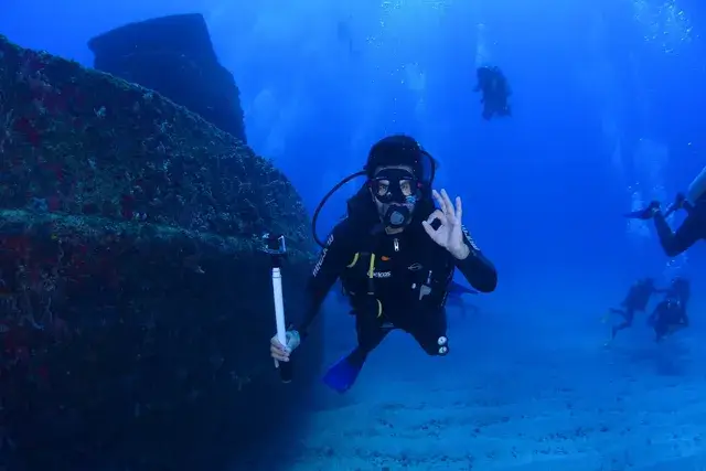 An image of a diving deep in the ocean in the color blue