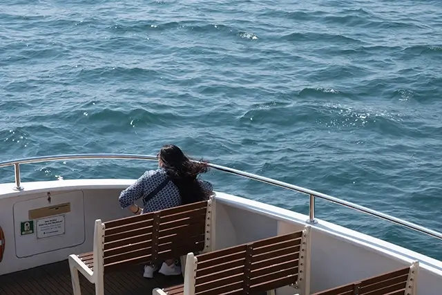 The passenger is traveling on the deck of the ship