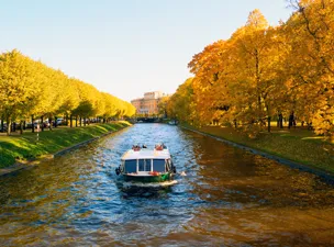 Fall cruise sailing through autumn foliage and golden tree