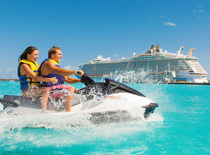 Two People Jet Skiing Near Cruise Ship
