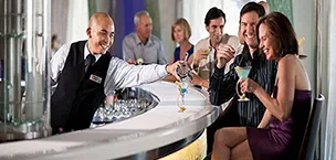 a person fills a glass with beverages and drinks