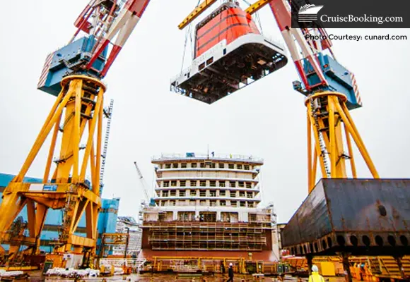 The iconic red and black Cunard funnel is crowned as Fincantieri reaches its latest construction milestone